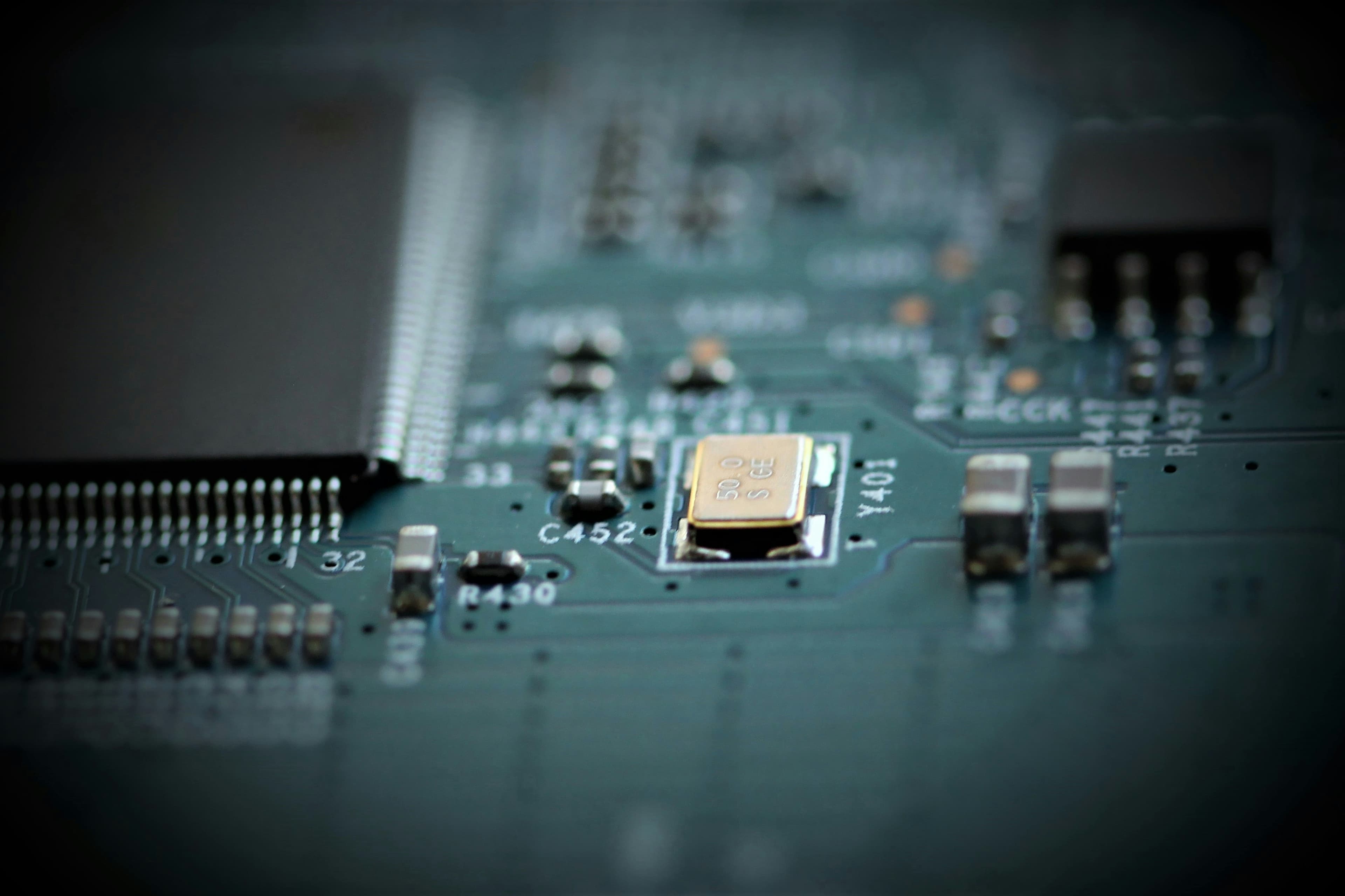 Circuit board macro — teal and gray tones
